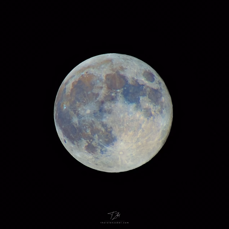 Close-up of the moon, which appears partially reddish and bluish due to the minerals found on the moon.
